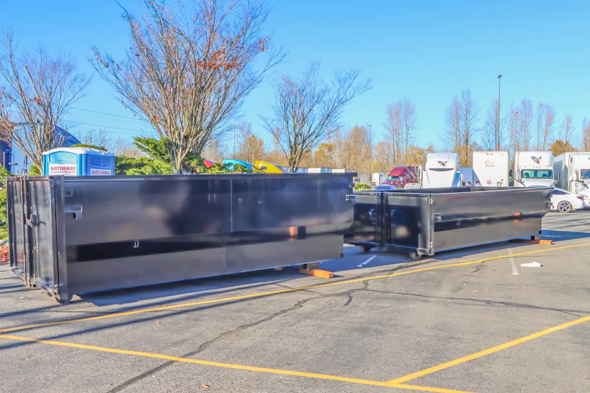 Professional dumpster rental service with roll-off container on residential driveway in Muscatine